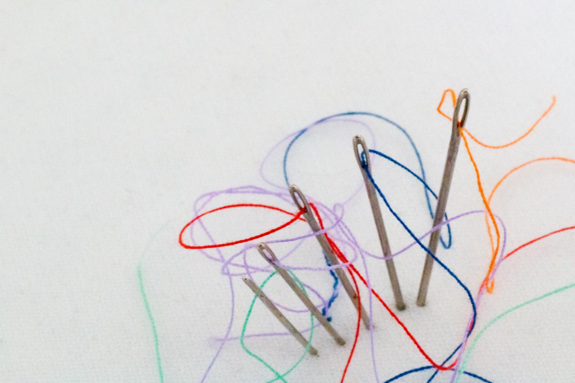 Compact set of threads and needles on paper
